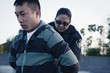 Policewoman handcuffing man