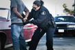 Hispanic policewoman handcuffing man
