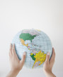 Woman holding inflatable globe