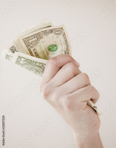 Photo: Woman gripping dollar bills Woman gripping dollar bills