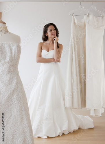 Photo: Mixed race woman trying on wedding dresses Mixed race woman trying on wedding dresses