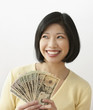 Filipino woman holding money and smiling