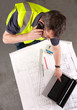 Builder phones about construction blueprint Builder phones about construction blueprint