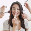 Hands applying makeup to Hispanic womanÕs face