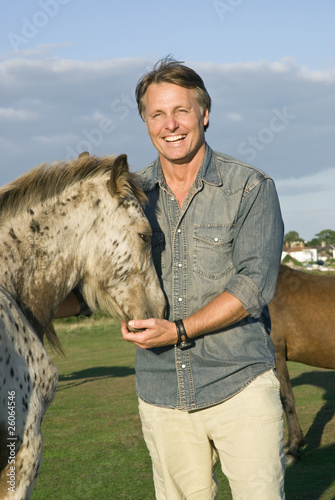 Photo: happy man petting his horse happy man petting his horse