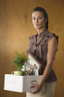 Businesswoman holding office belongings