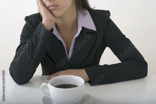 Photo: Mixed race businesswoman drinking coffee Mixed race businesswoman drinking coffee