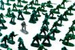 Grey Soldier Among Green Toy Soldiers