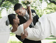 Groom holding bride