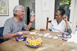 Home nurse and elderly man playing cards