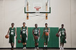 Photo : Serious African basketball players dribbling balls in gym Serious African basketball players dribbling balls in gym