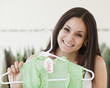 Mixed race woman shopping in clothing store