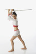 Mixed race woman performing martial arts with sword