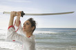 Mixed race woman performing martial arts with sword