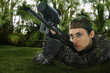 Mixed race woman in combat gear with rifle