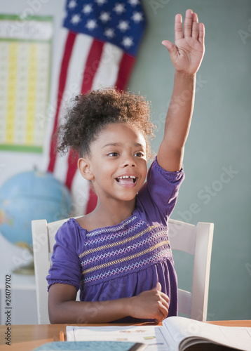 Photo: Mixed race girl answering question in classroom Mixed race girl answering question in classroom