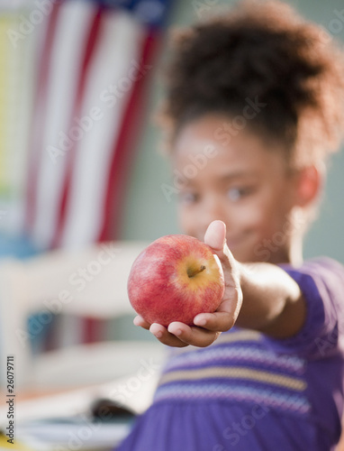 Photo: Mixed race girl holding apple Mixed race girl holding apple