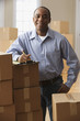 African man with clipboard and moving boxes