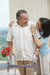 Hispanic woman encouraging husband using walker