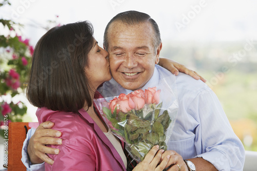Photo: Hispanic man giving wife flowers Hispanic man giving wife flowers