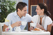 Hispanic couple having breakfast in cafe