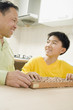 Chinese grandfather teaching abacus to grandson