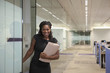 Black businesswoman carrying folder