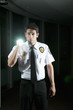 Hispanic security guard checking dark offices