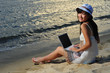 Little Chinese Asian girl on beach with laptop Little Chinese Asian girl on beach with laptop