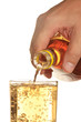 man's hand pours a drink into a glass
