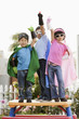 Korean children in superhero costumes with arms raised