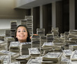 Mixed race woman surrounded by stacks of money