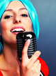Funky female pop singer with an old microphone