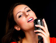 Young female star performer singing with old fashioned microphon