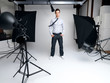 Successful young male fashion model standing in his studio