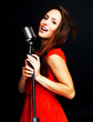 Young female jazz singer singing with old fashioned microphone
