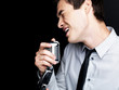 Young male star singer singing into old fashioned microphone