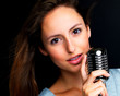 Beautiful singing rockstar girl on dark background