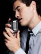 Male star singer singing with old fashioned microphone