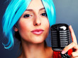 Young female jazz singer holding an retro microphone