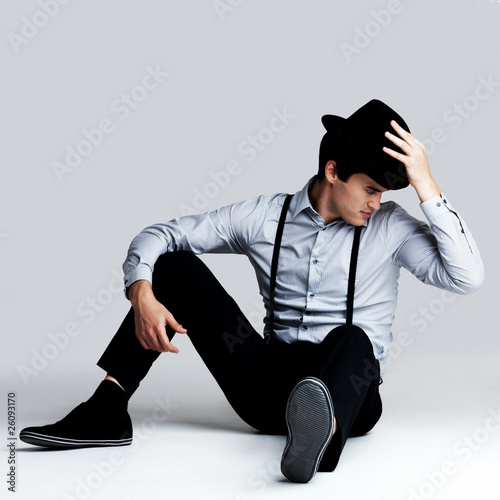 Photo: Handsome young guy posing with hat - Copyspace Handsome young guy posing with hat - Copyspace