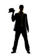 Young man standing with his hat in hand on white
