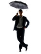 Handsome young business man standing under umbrella