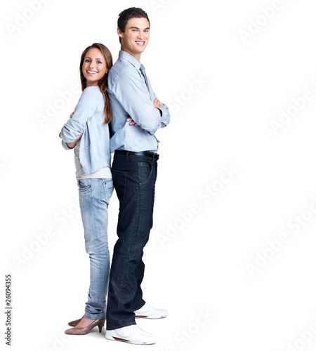 Photo: Happy young couple standing back to back Happy young couple standing back to back