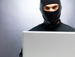 Photo: Company information - Male thief stealing data from laptop Company information - Male thief stealing data from laptop