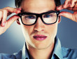 Closeup of a smart young guy wearing glasses