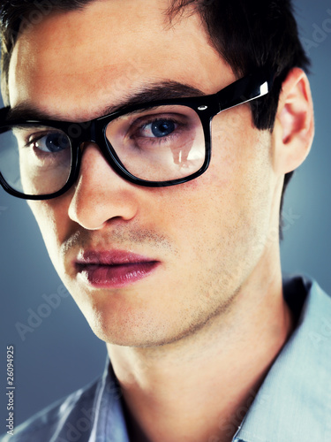 Photo: Closeup of a handsome young man in glasses Closeup of a handsome young man in glasses