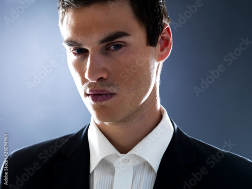 Photo: Handsome young businessman looking at you Handsome young businessman looking at you