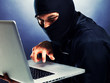 Photo: Computer hacker - Male thief stealing data from laptop Computer hacker - Male thief stealing data from laptop