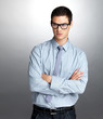 Smart young male executive looking away in thought